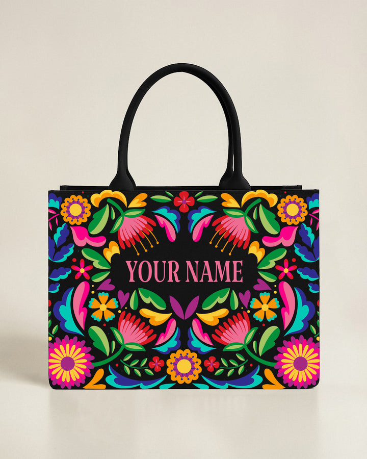 Black personalized tote bag with an ornate gold and teal sun and moon frame, featuring a custom name centered in elegant gold typography.