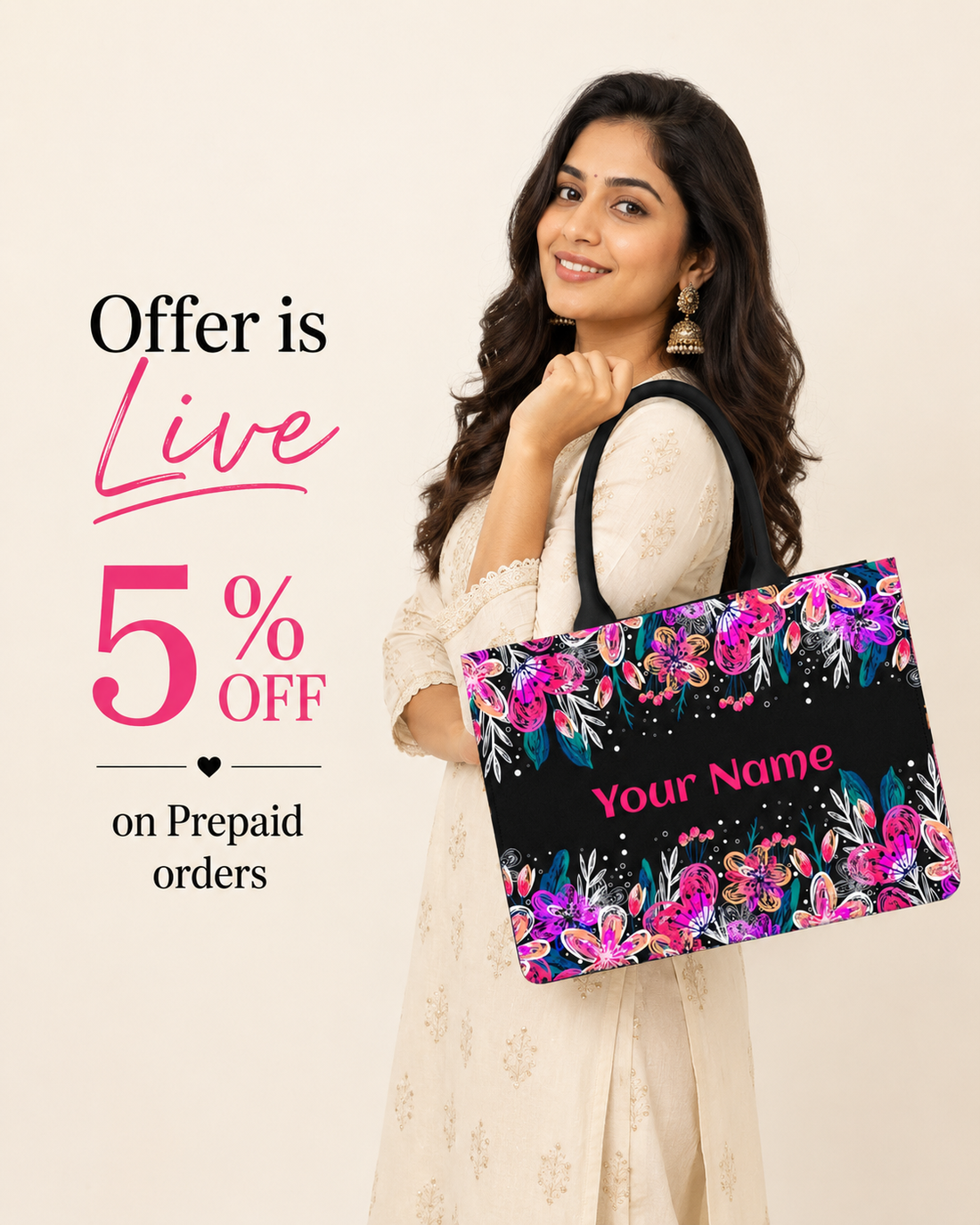 Indian female model wearing a cream ethnic outfit holding a custom floral tote bag with personalized name on an off-white background, promoting 5% off on prepaid orders.