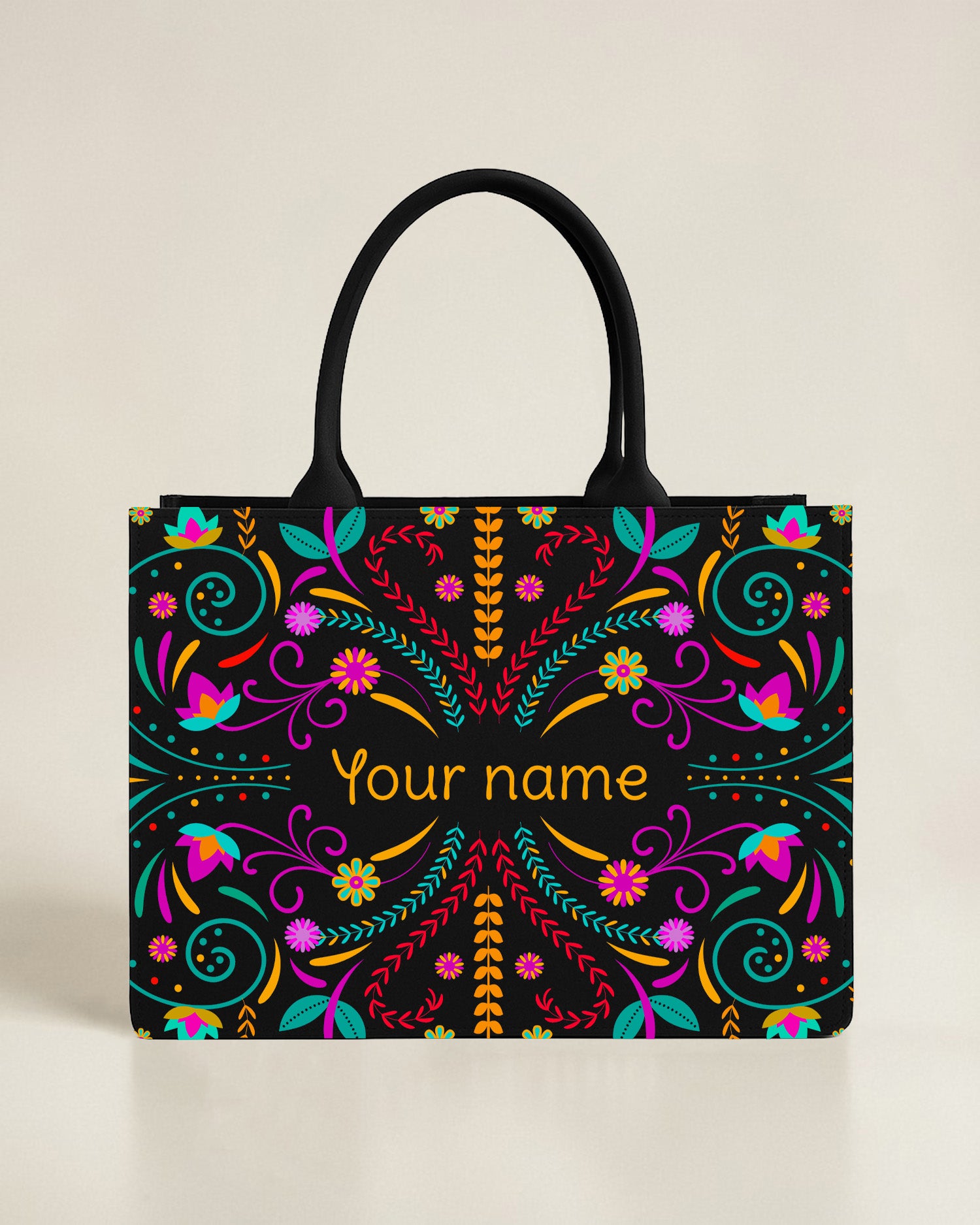 Black personalized tote bag with a colorful peacock and floral motif in the bottom corner, featuring a custom name in a bright lime-green font.