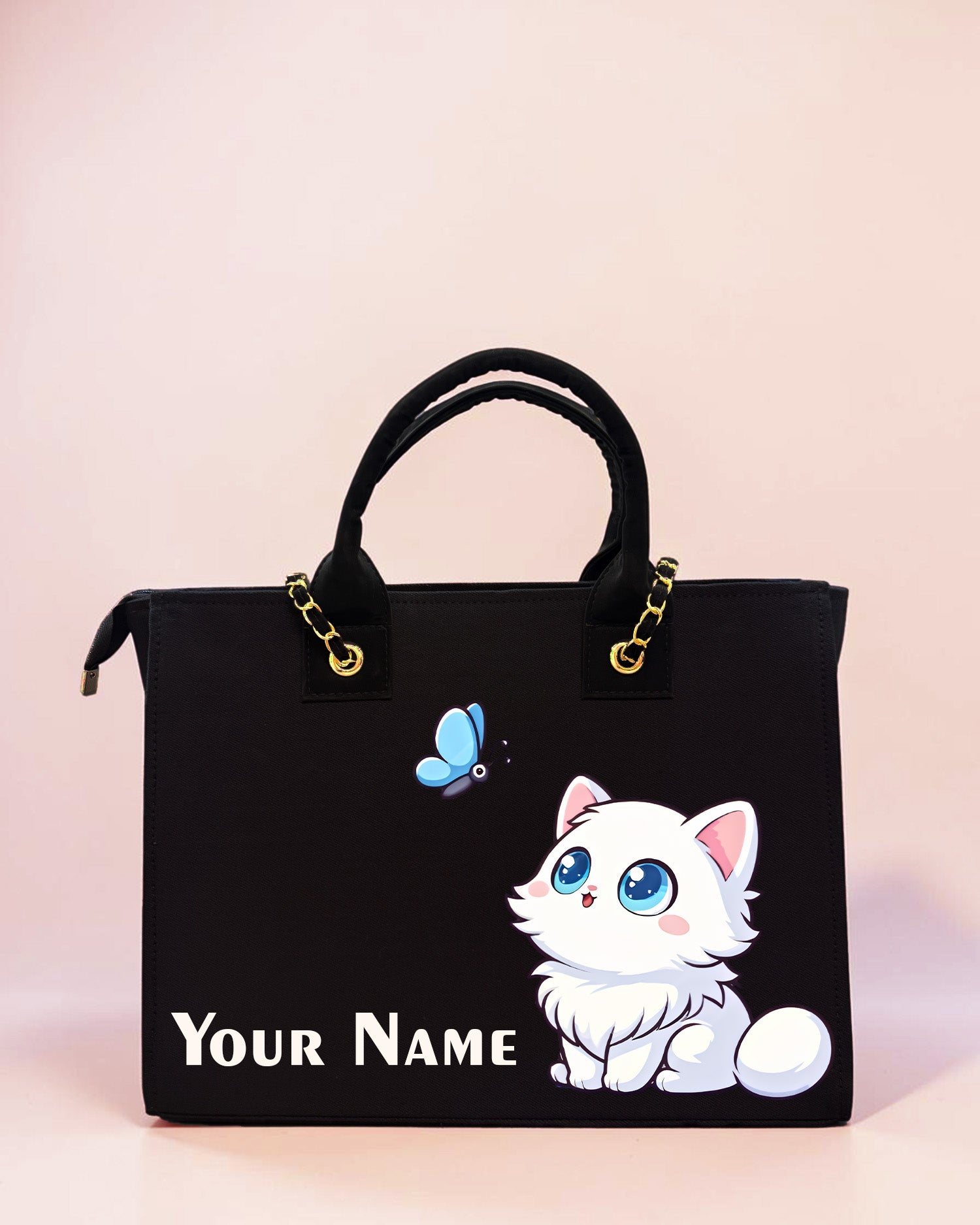 Personalized black tote bag featuring cute white cat illustration, butterfly artwork, and custom name print on a pastel background.