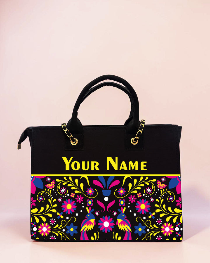 Personalized black folk art tote bag with colorful floral print and custom name